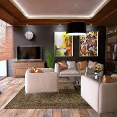 Elegantes habitaciones de una casa con sofás cómodos, arte abstracto y una estantería llena de libros.