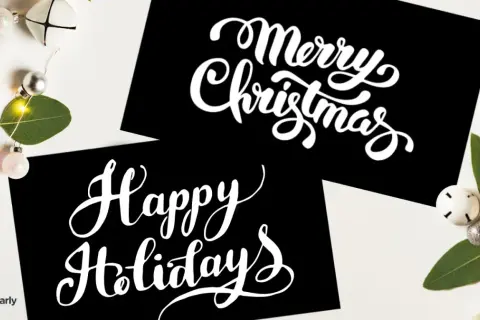 Tarjetas negras con letras blancas: "Merry Christmas" y "Happy Holidays". Aprende cómo se dice feliz navidad en inglés.