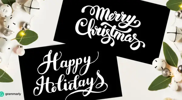 Tarjetas negras con letras blancas: "Merry Christmas" y "Happy Holidays". Aprende cómo se dice feliz navidad en inglés.