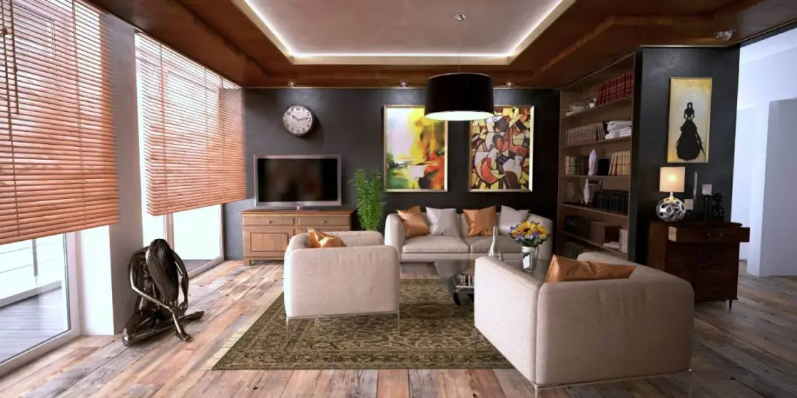 Elegantes habitaciones de una casa con sofás cómodos, arte abstracto y una estantería llena de libros.