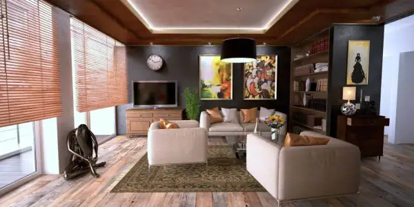 Elegantes habitaciones de una casa con sofás cómodos, arte abstracto y una estantería llena de libros.